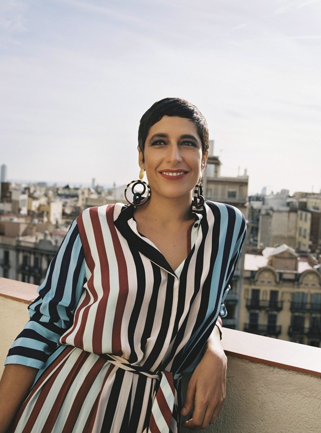 Malika Favre photographed in Barcelona, wearing a striped dress that reflects her visual style.